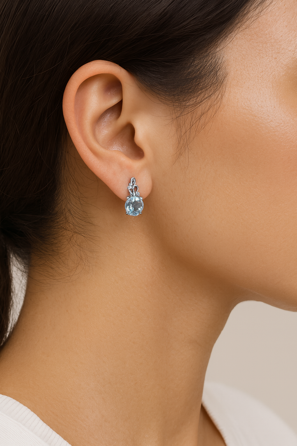 Blue drop earrings on ear model 