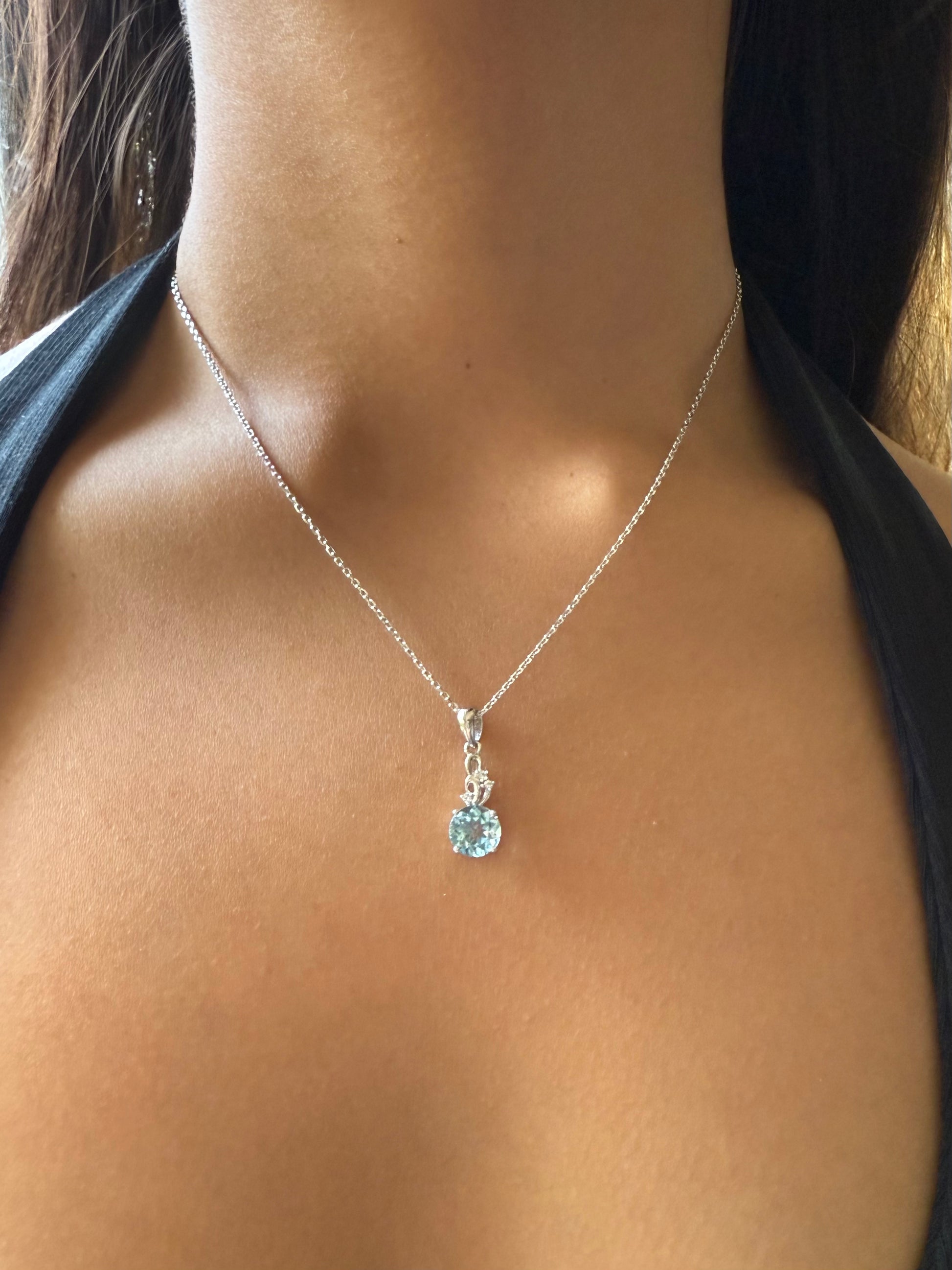 Necklace with a pendant worn by a person