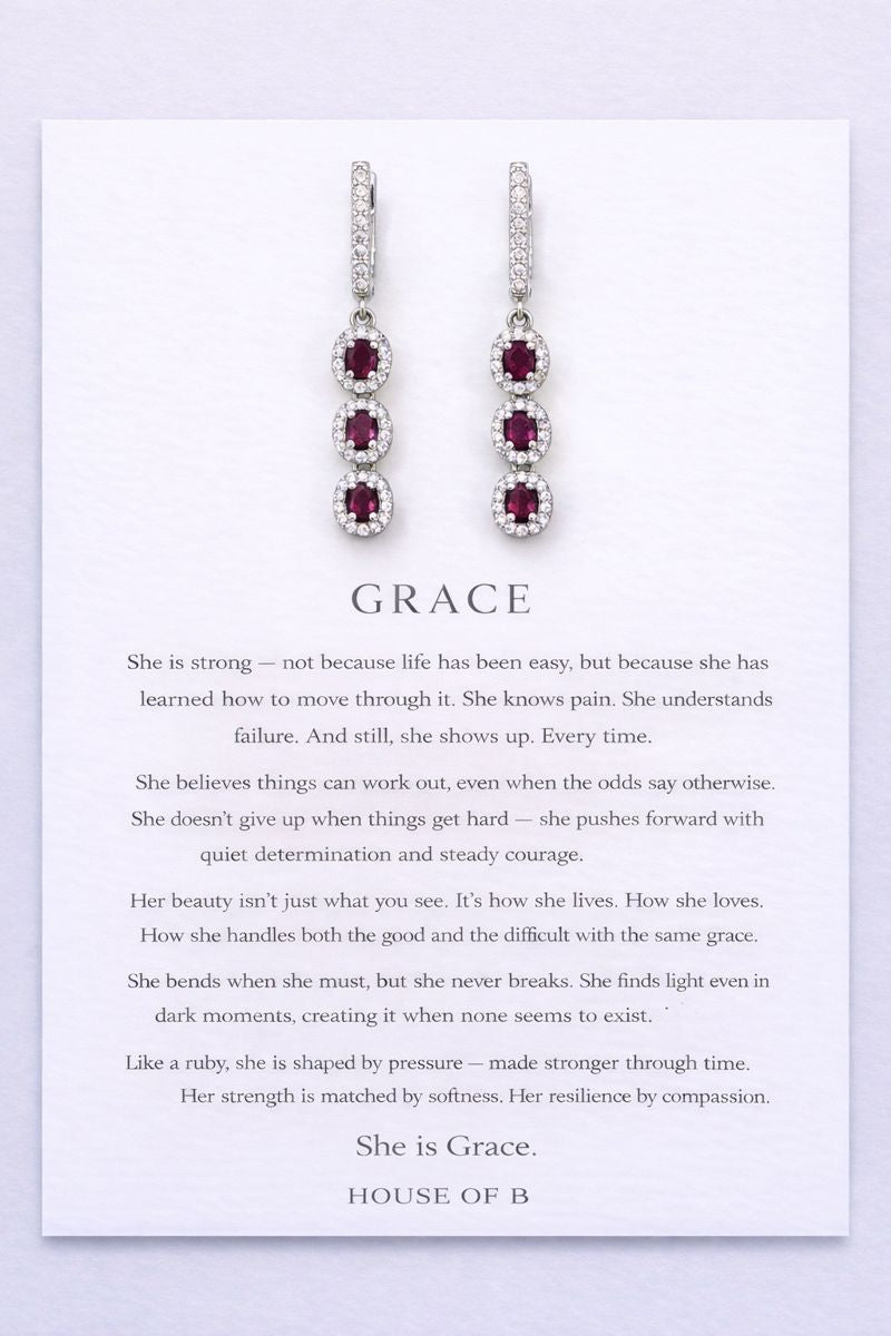 Earrings on a card with text about 'Grace' on a light purple background