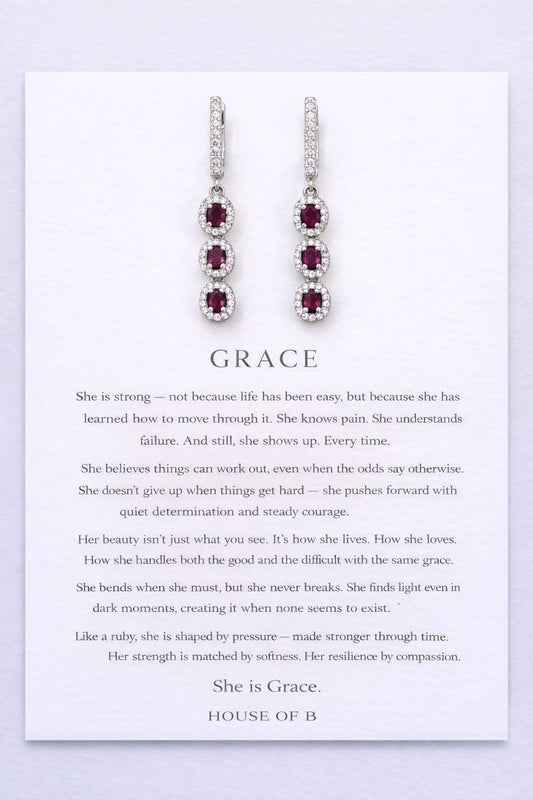 Earrings on a card with text about 'Grace' on a light purple background