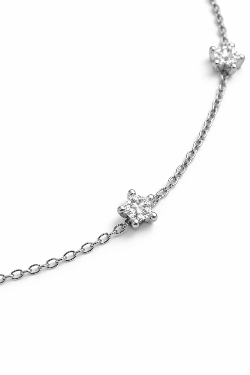 Silver bracelet with diamond-like stones on a white background
